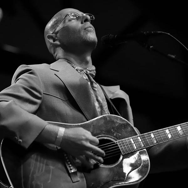 Jared Tyler with his guitar, photo by Gary Hart